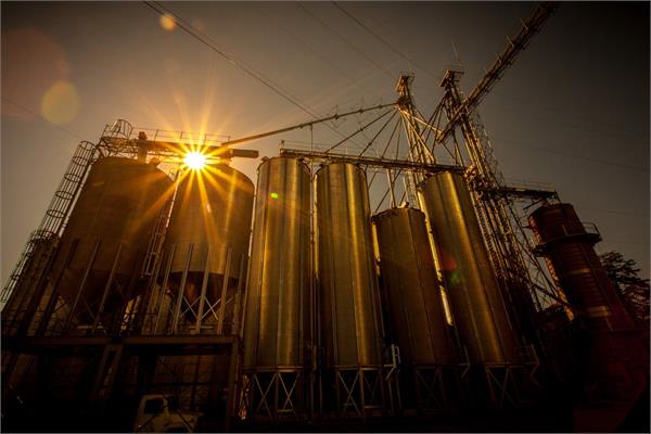 A production facility at sunset, seen from below